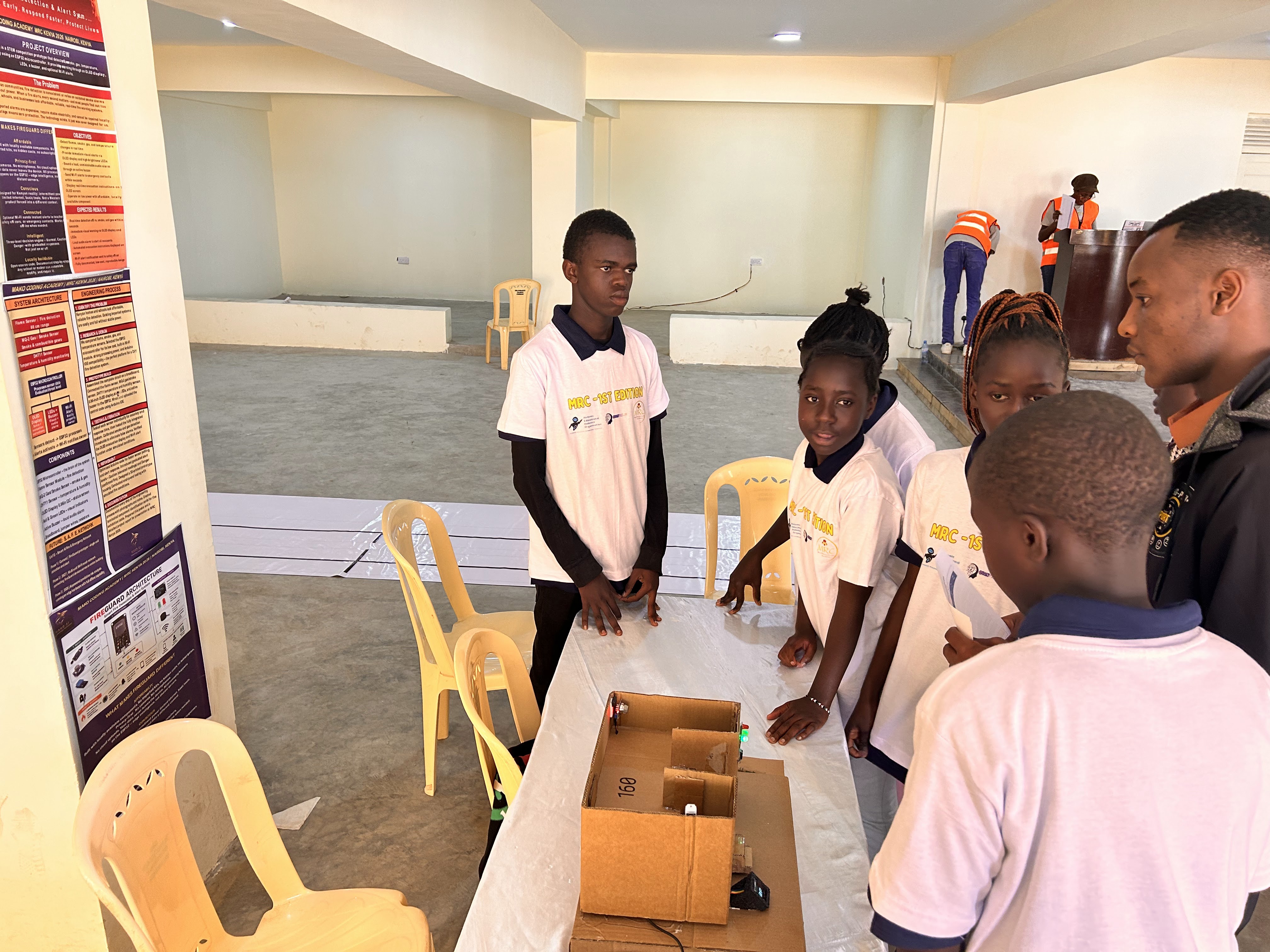 A participant presenting a project to MRC Kenya visitors