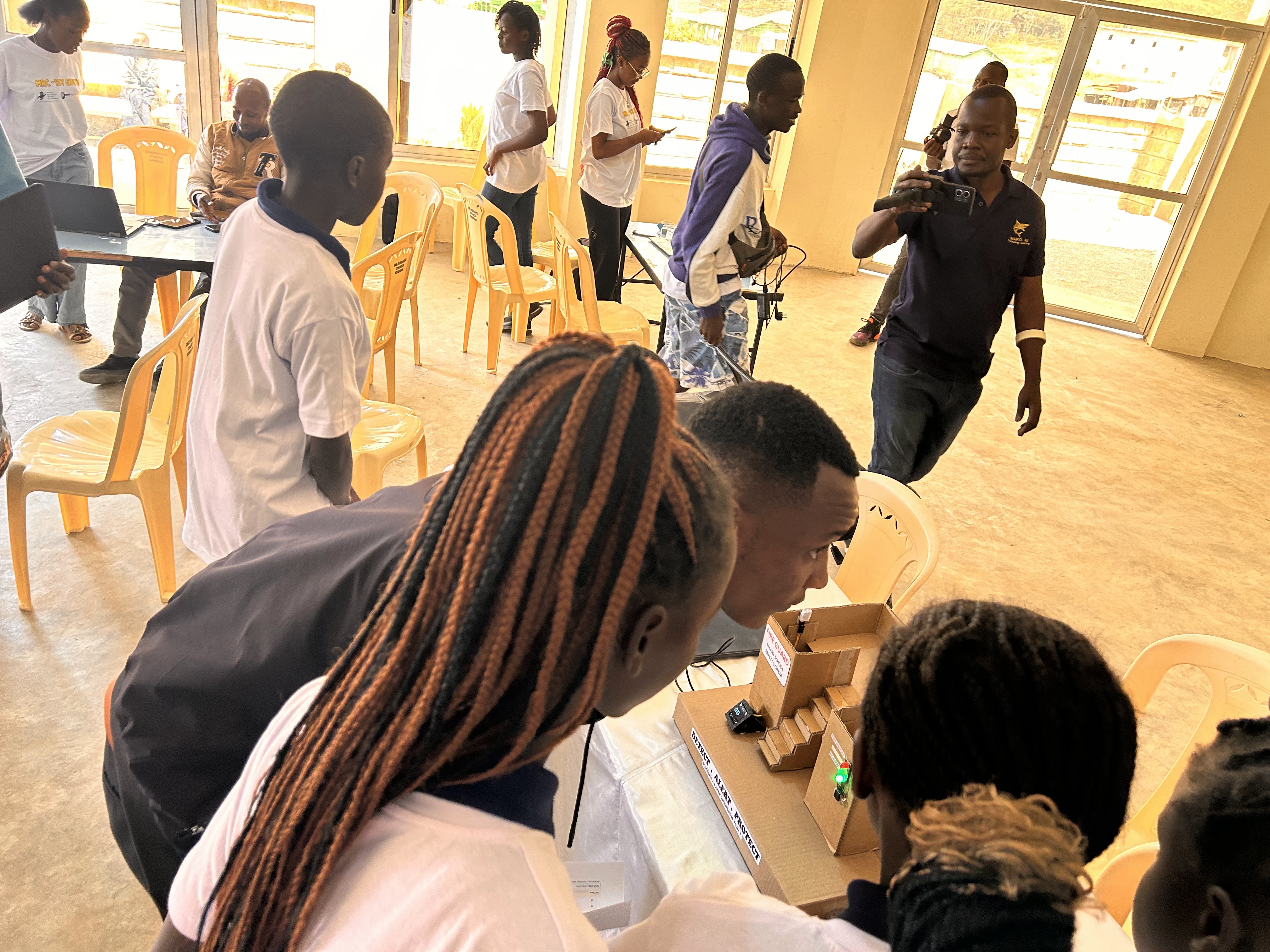 MRC Kenya participants gathered around an exhibition table