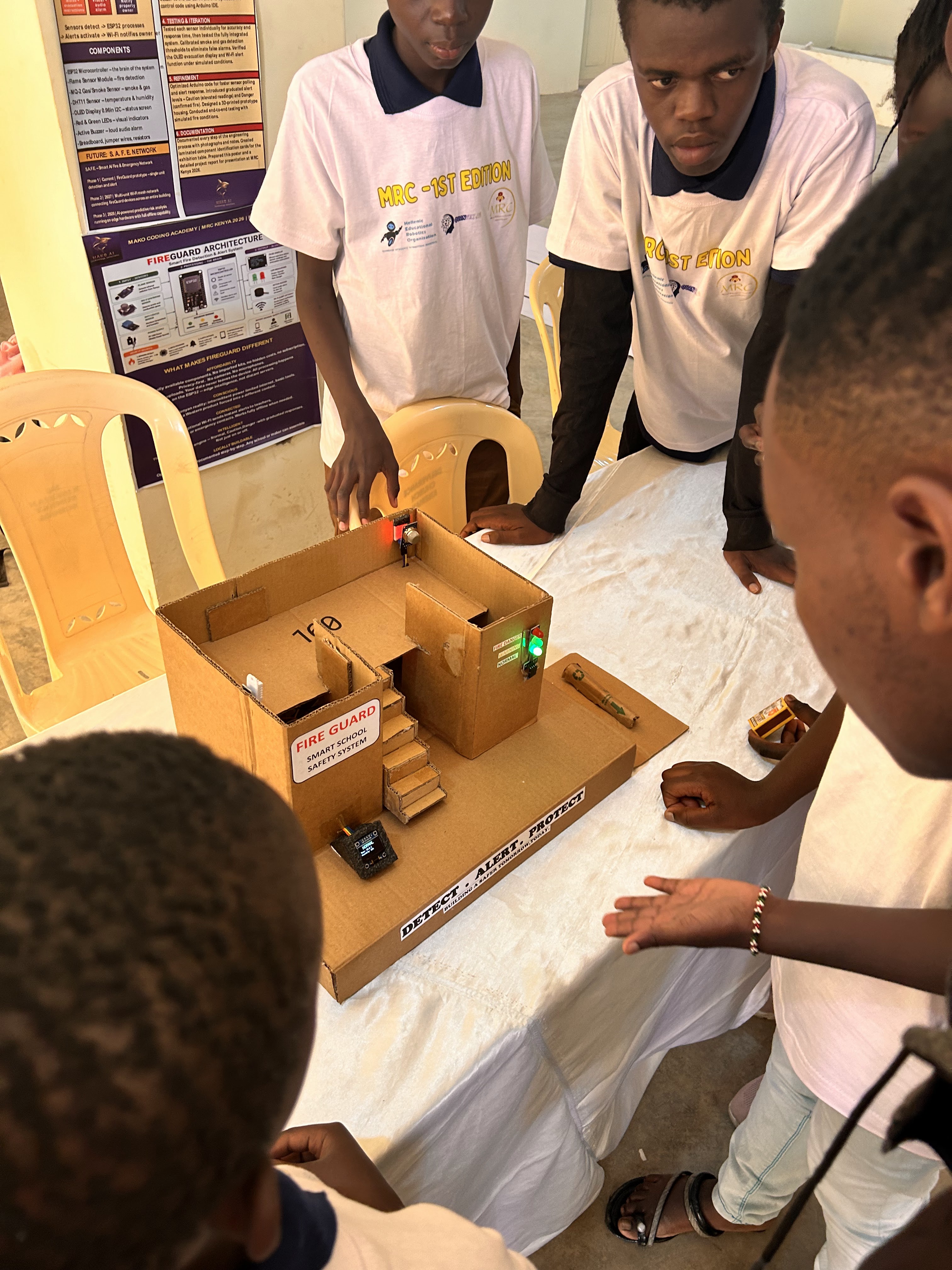 Young competitors preparing a robot for the arena