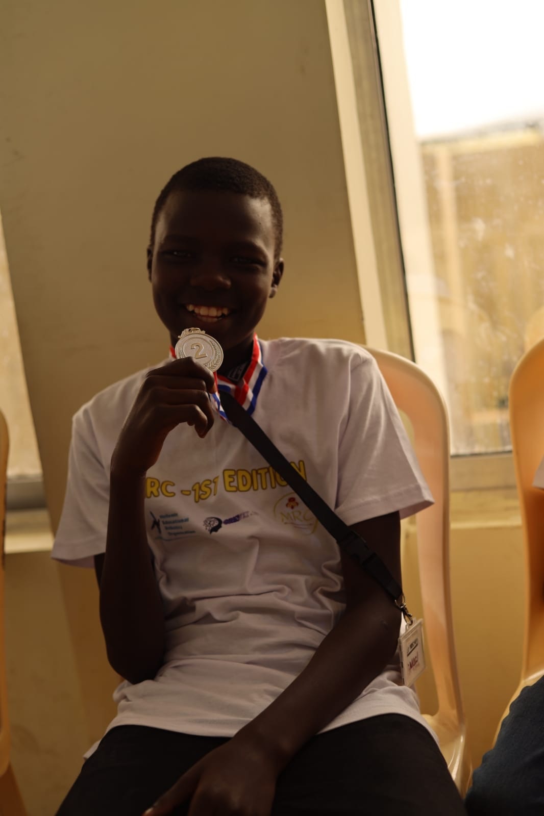 Young MRC Kenya competitor proudly showing a medal
