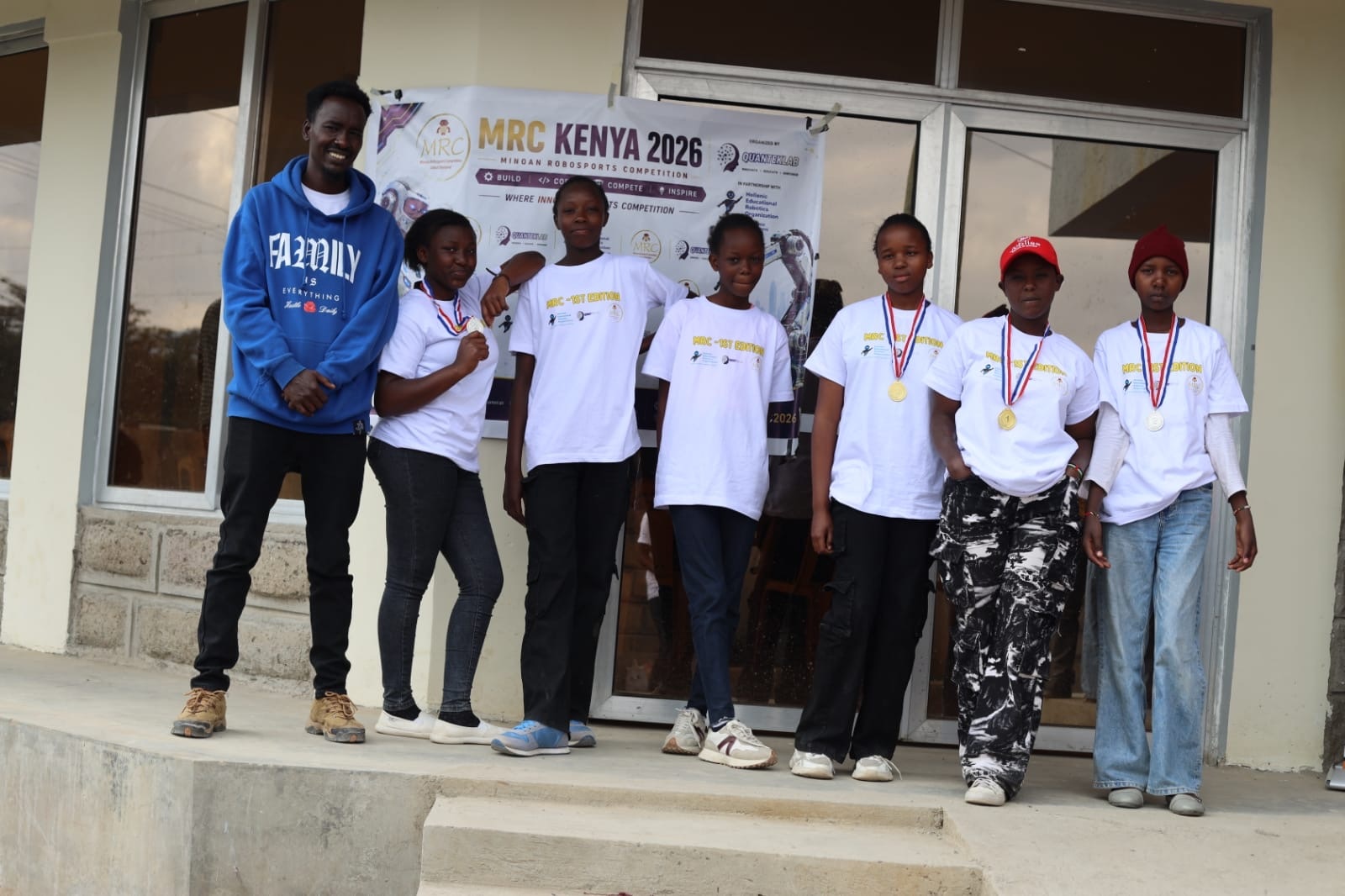 MRC Kenya students and coaches posing together after receiving medals